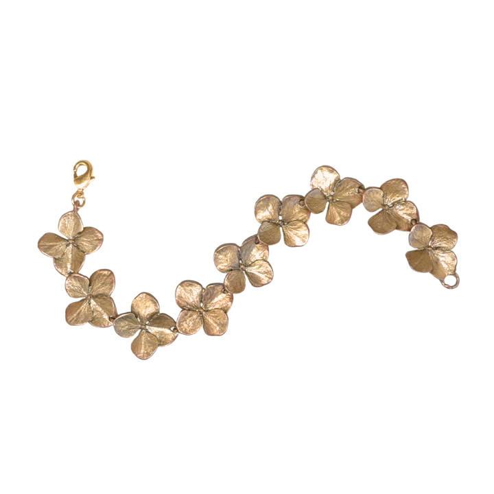 Gold bracelet with floral designs on a white background