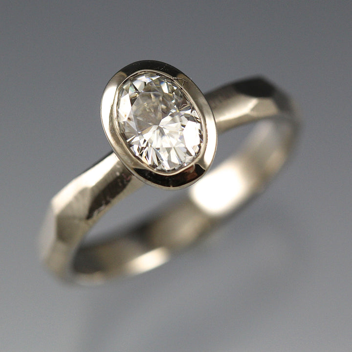 Bezel Set Oval Moissanite Engagement Ring featuring a organic faceted band in 14k white gold