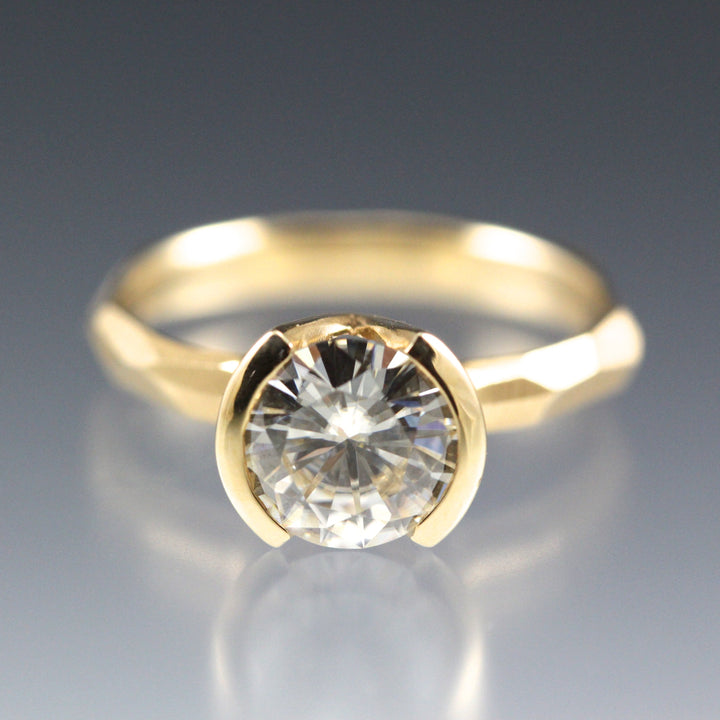 Modern 14k yellow gold Engagement Ring with a Partial Bezel containing a Moissanite Stone