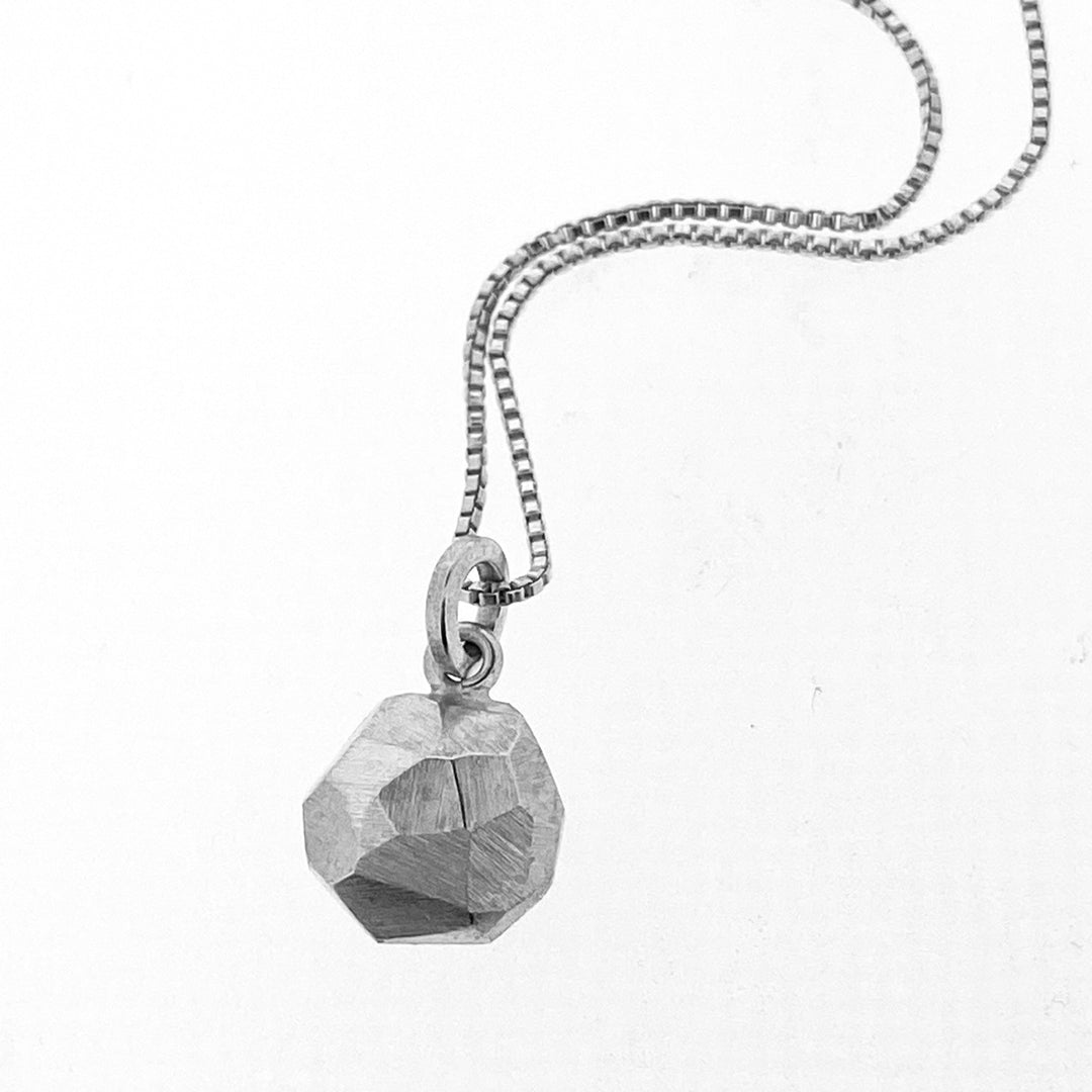 Full view of octagon pendant on silver chain.