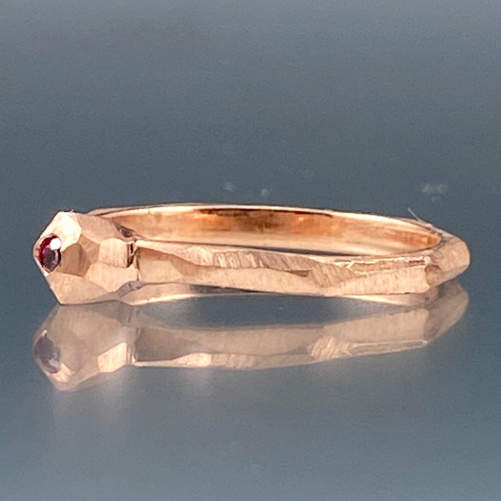 Side view of pink sapphire nugget facet ring.