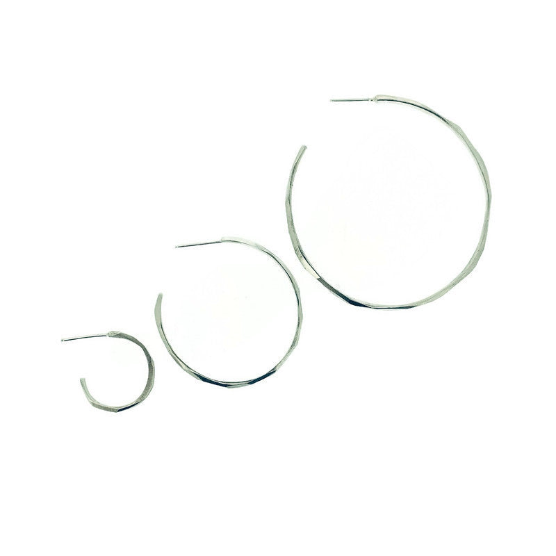 Full image of a large, medium, and small faceted hoop earring all next to each other to compare size.