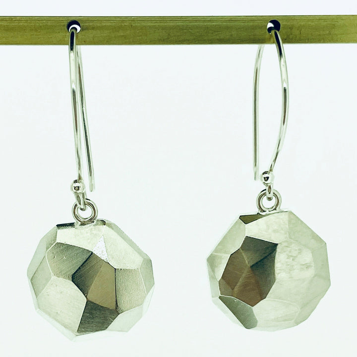 Full view of Faceted dangle Earrings on earring post.