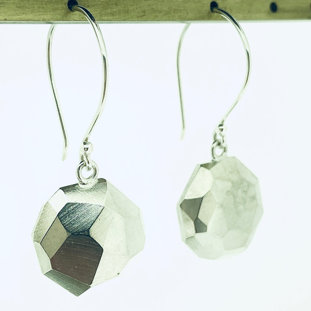 Angled view of faceted Dangle Earrings.