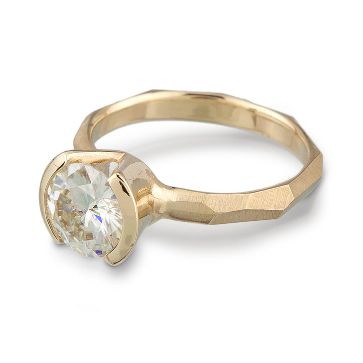 Modern 14k yellow gold Engagement Ring with a Partial Bezel containing a Moissanite Stone
