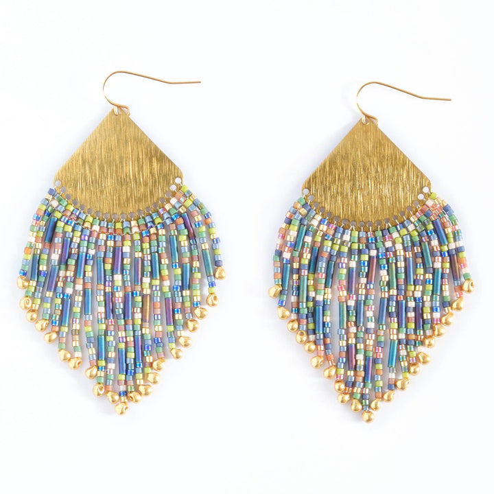Pair of beaded earrings with gold fringe on a white background