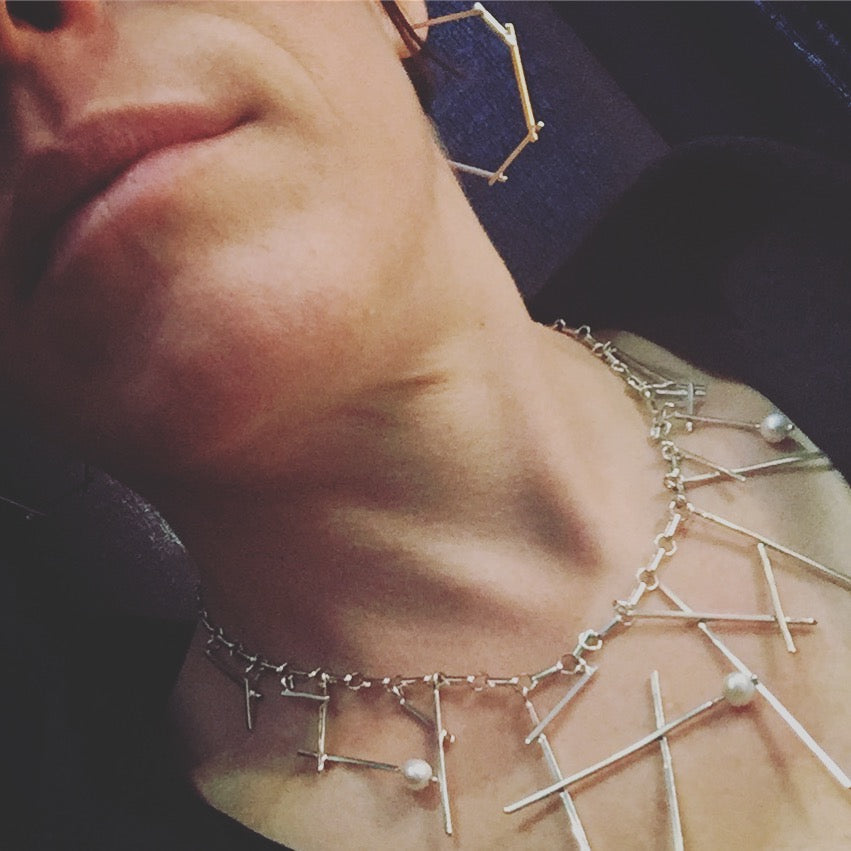 Full view of Sticks and Pearls necklace on woman's neck to help give idea of scale of piece.