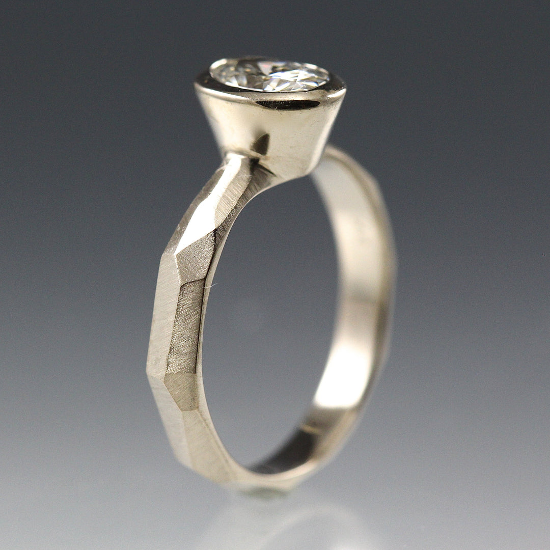 Side view of a Bezel Set Oval Engagement Ring featuring a organic faceted band in 14k white gold