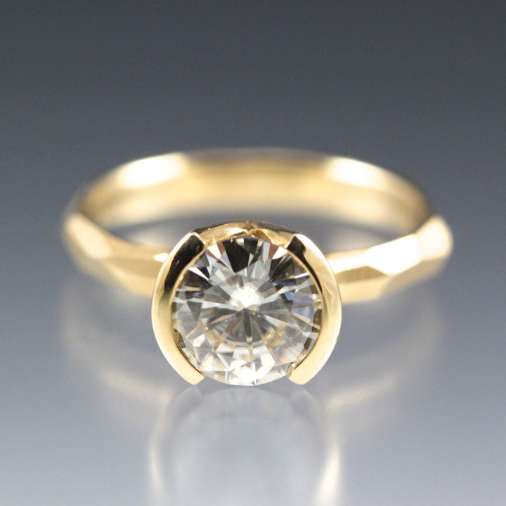 Modern 14k yellow gold Engagement Ring with a Partial Bezel containing a Moissanite Stone 