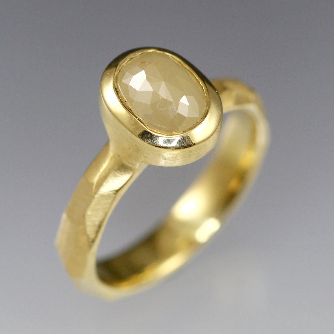 A creamy natural colored rose cut diamond solitaire ring in 18k yellow gold.
