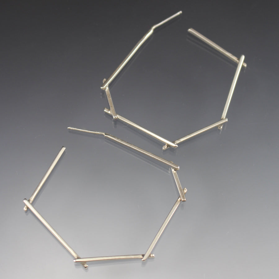 Full image of Medium Stick Hoop Earrings. These hoop earrings are made of silver square wire that are soldered together to look like sticks.