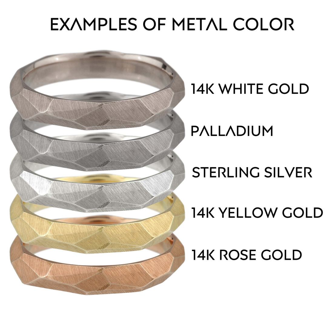 Full view of five different metal colored skinny facet rings stacked on top of one another.