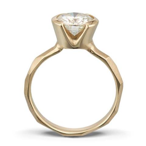Side view of a Modern 14k yellow gold Engagement Ring with a Partial Bezel, allowing light to shine through the Moissanite Stone.