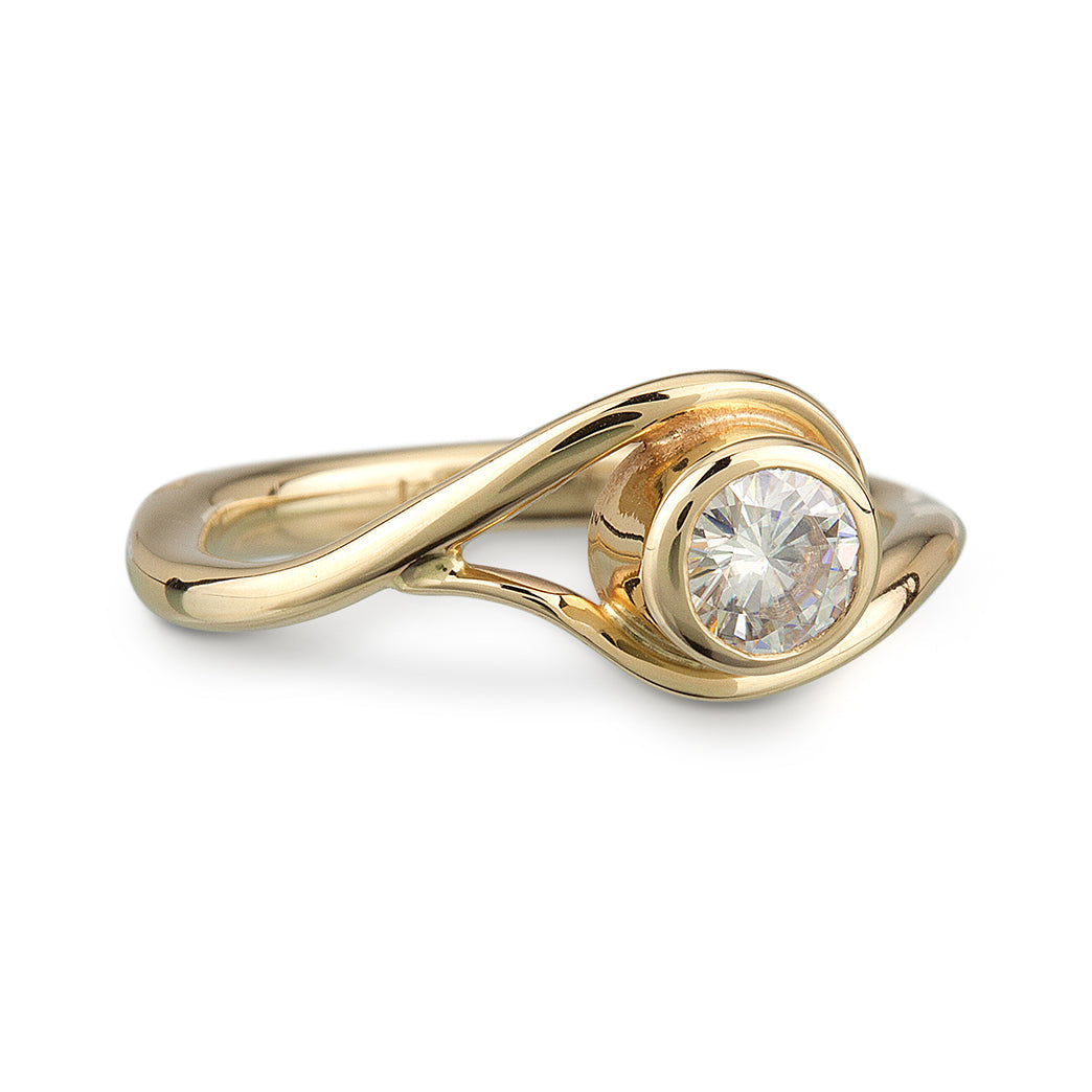 Yellow Gold and Moissanite Engagement Ring, the metal gently wraps around the stone, like a vine or wave.