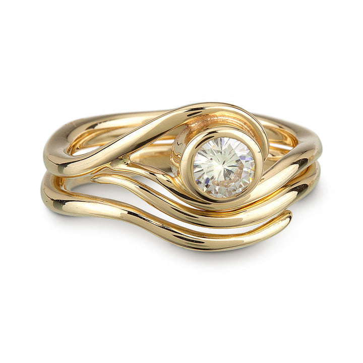 A Vine inspired Yellow Gold and Moissanite Engagement ring and nesting wedding band.