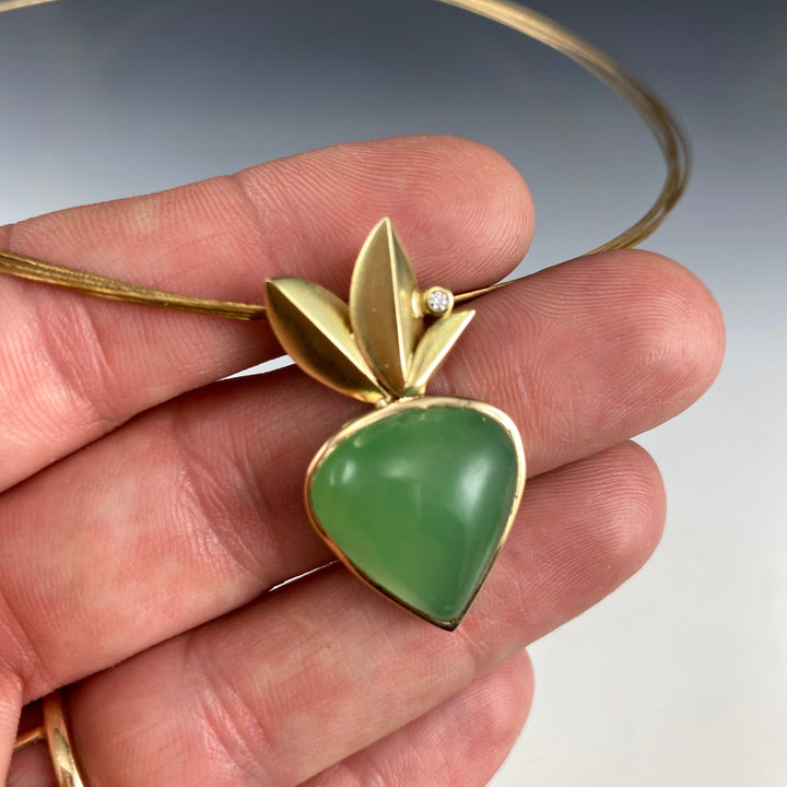 Full image of Chrysoprase pendant on hand to give scale of pendant.