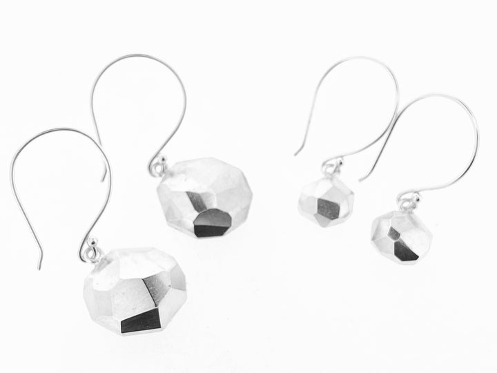 Full view of small and large octagon faceted Dangle Earrings right next to each other on a white background.