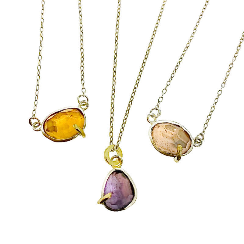 Full view of three different colored pendants (citrine, lilac and pink) all next to one another.