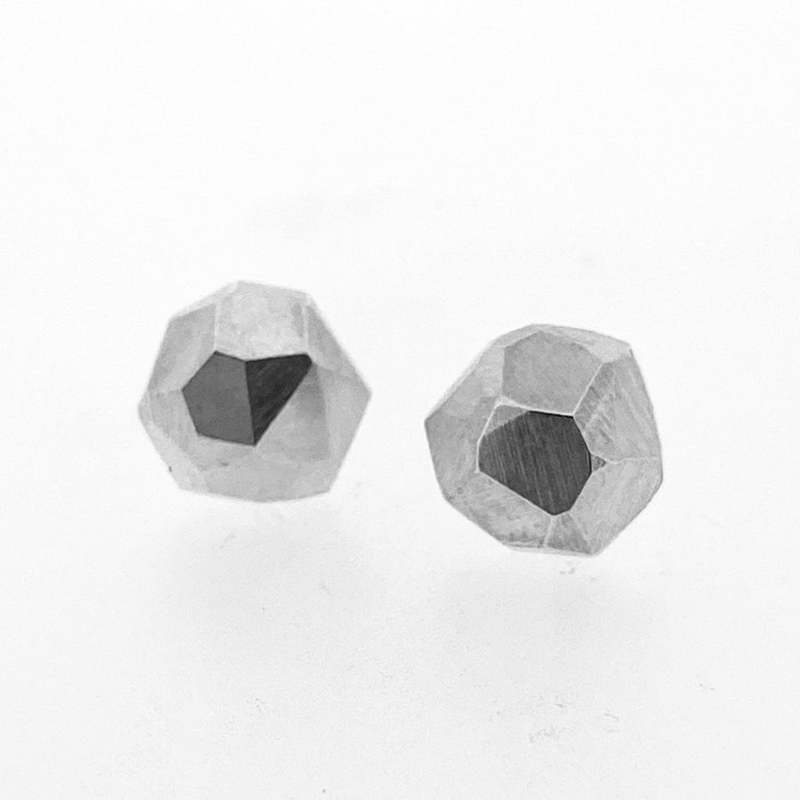 Full image of faceted Stud Earrings in the shape of a straight lined circle with a faceted texture on top.