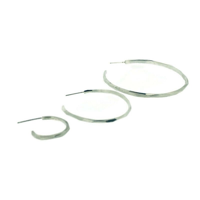 Angled view of a large, medium, and small faceted hoop earring all next to each other to compare size.
