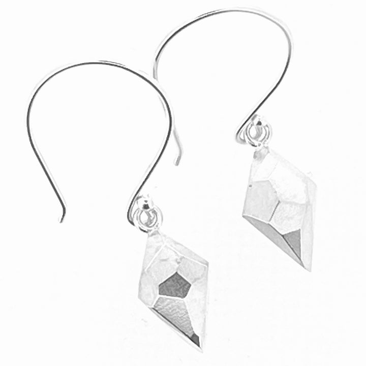 Full view of Faceted Dangle Earrings in the shape of a diamond. These dangle earrings have a big earring hook to which the diamond shaped pendant is attached with a faceted texture.