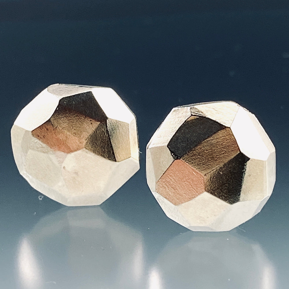 Full view of faceted Cufflinks with a grayscale background.